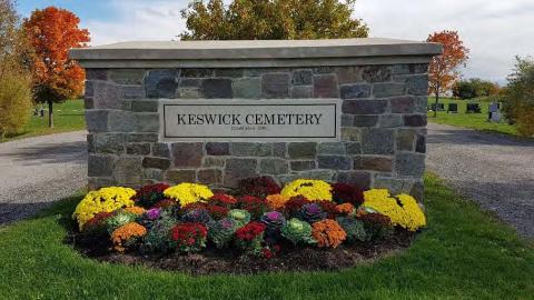 Entrance to Keswick Cemetery with red, yellow and orange flowers