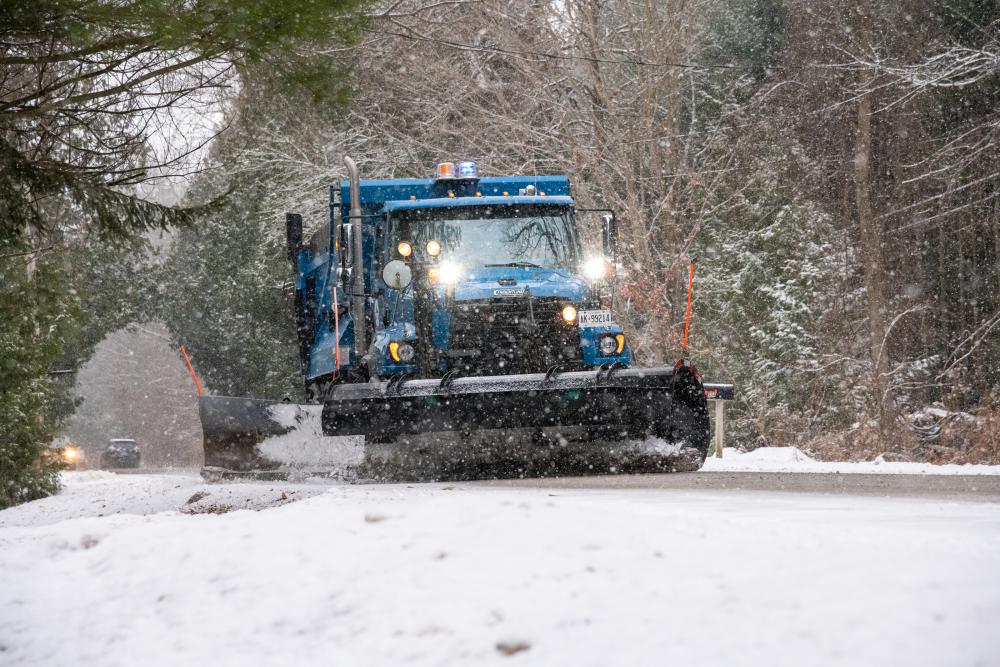 snowplow plowing a snowy road