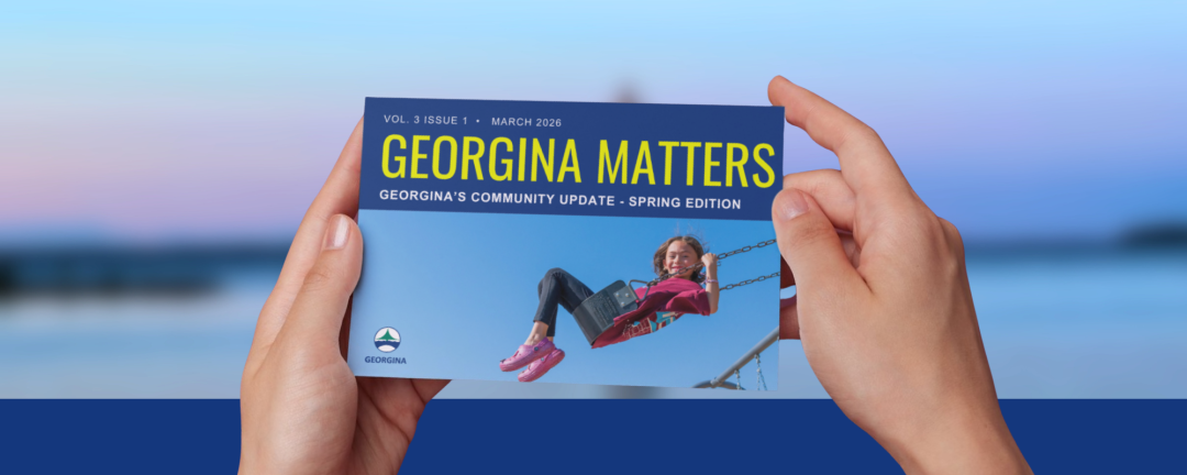 hands holding a paper newsletter called Georgina Matters